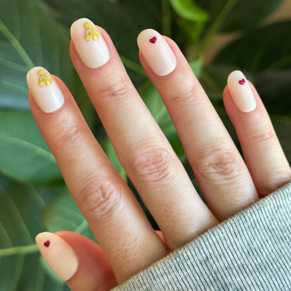Tiny Teddy Hearts - Press On | Short | Round pinky-beige nails with tiny gold teddy and red heart accents for a quick mani