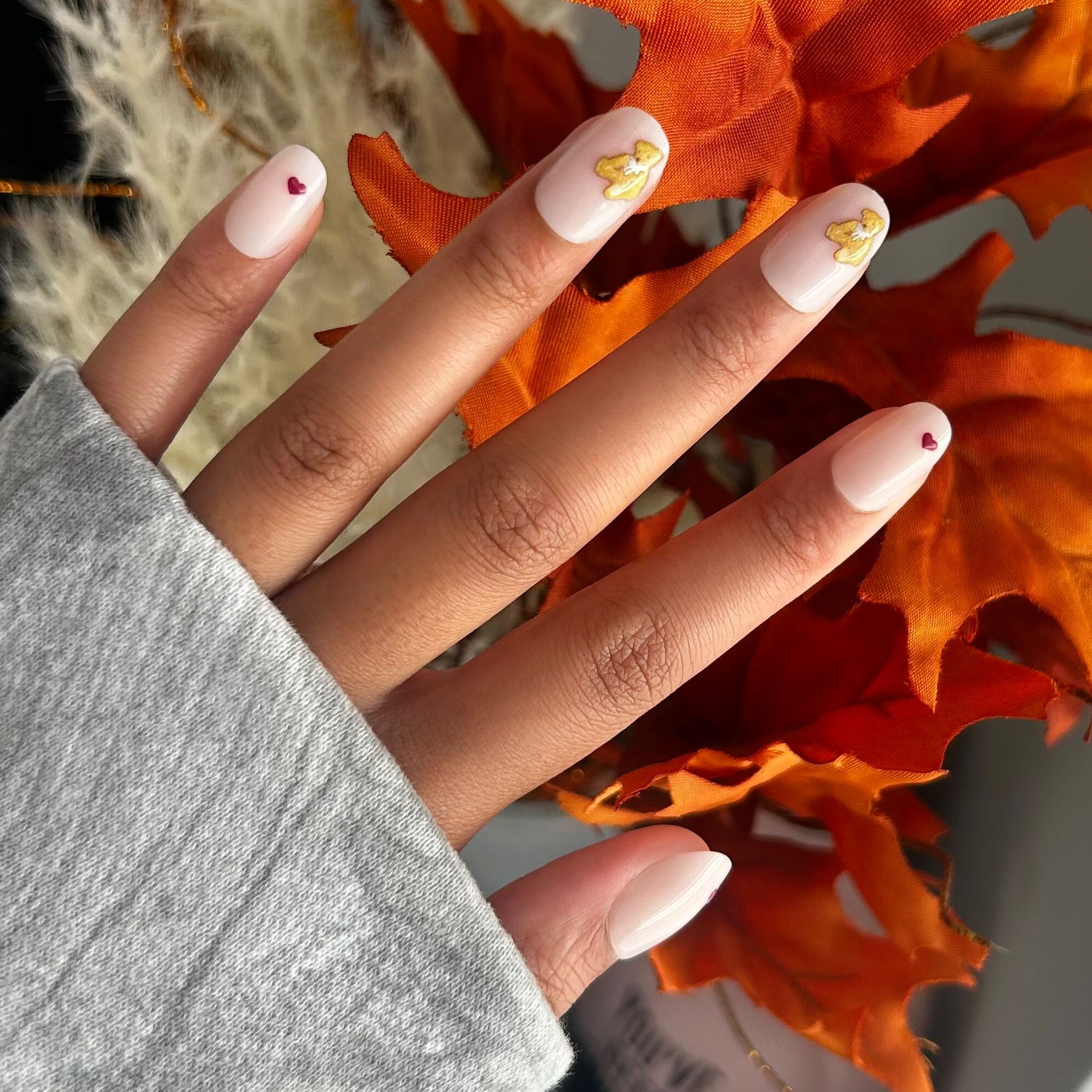 Tiny Teddy Hearts - Press On | Short | Round nails in soft pinky beige with tiny teddy and small heart details for an easy mani