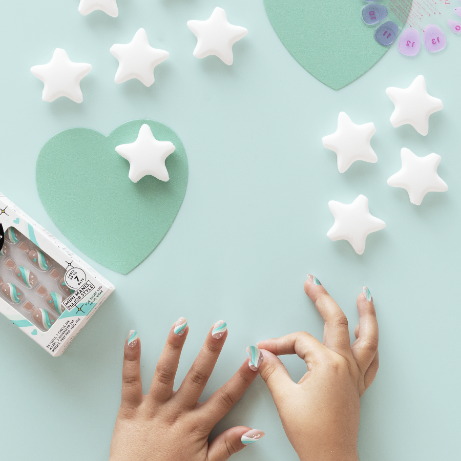 Totally Teal Swirls - Pressies | Short Medium | Round showing hands with teal swirl press on nails and star-shaped nail care tools