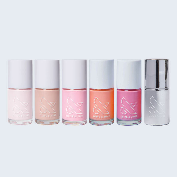 Five pastel nail polish bottles in pink and peach tones from the Summer Sorbet Set by Olive and June