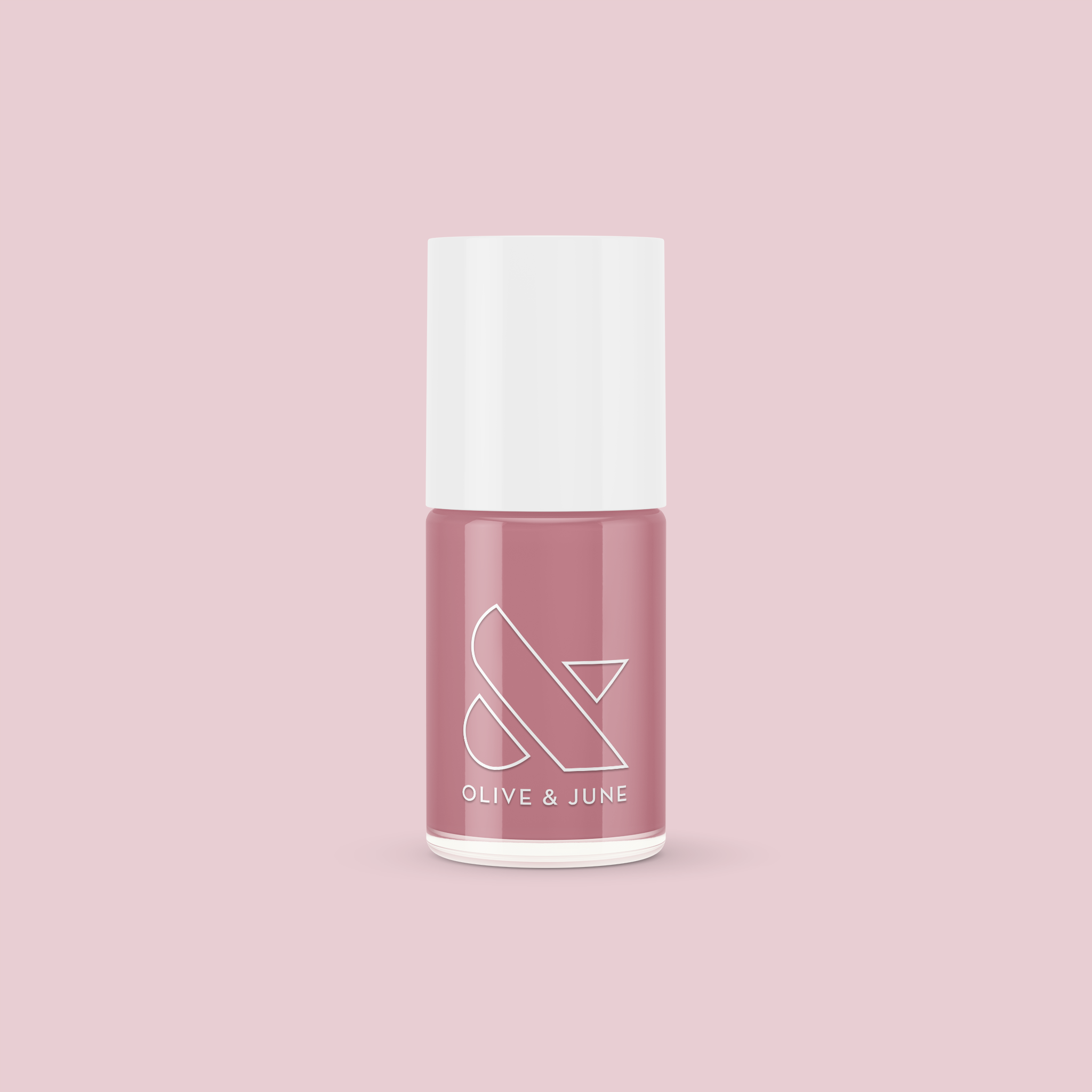 Bottle of Yogurt Parfait nail polish in dusty rose pink shade by Olive and June on light pink background