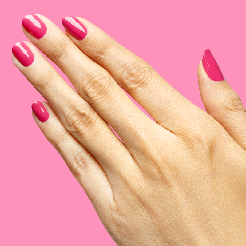 Hand with nails painted in vibrant magenta using Wild Orchid - Gel for a bold, long-lasting manicure at home