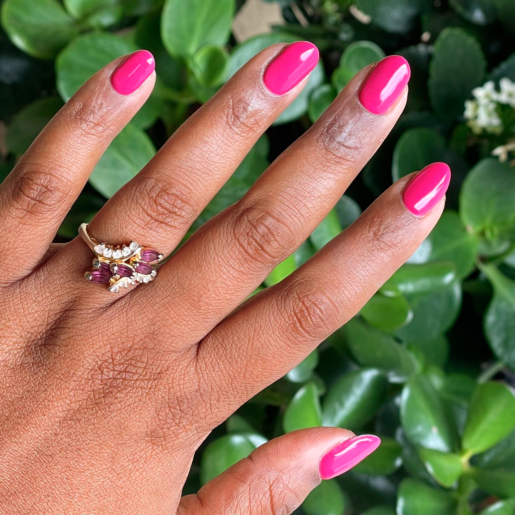 Hand with nails painted vivid magenta using Wild Orchid - Gel polish for a bold and durable manicure at home