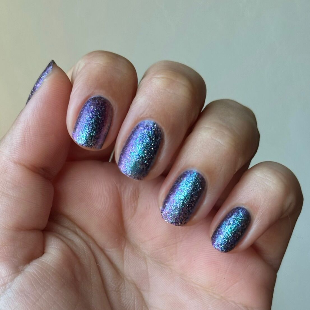 You Obviously Need It iridescent glitter gel polish with purple-blue shimmer on natural medium nails for a sparkling mani
