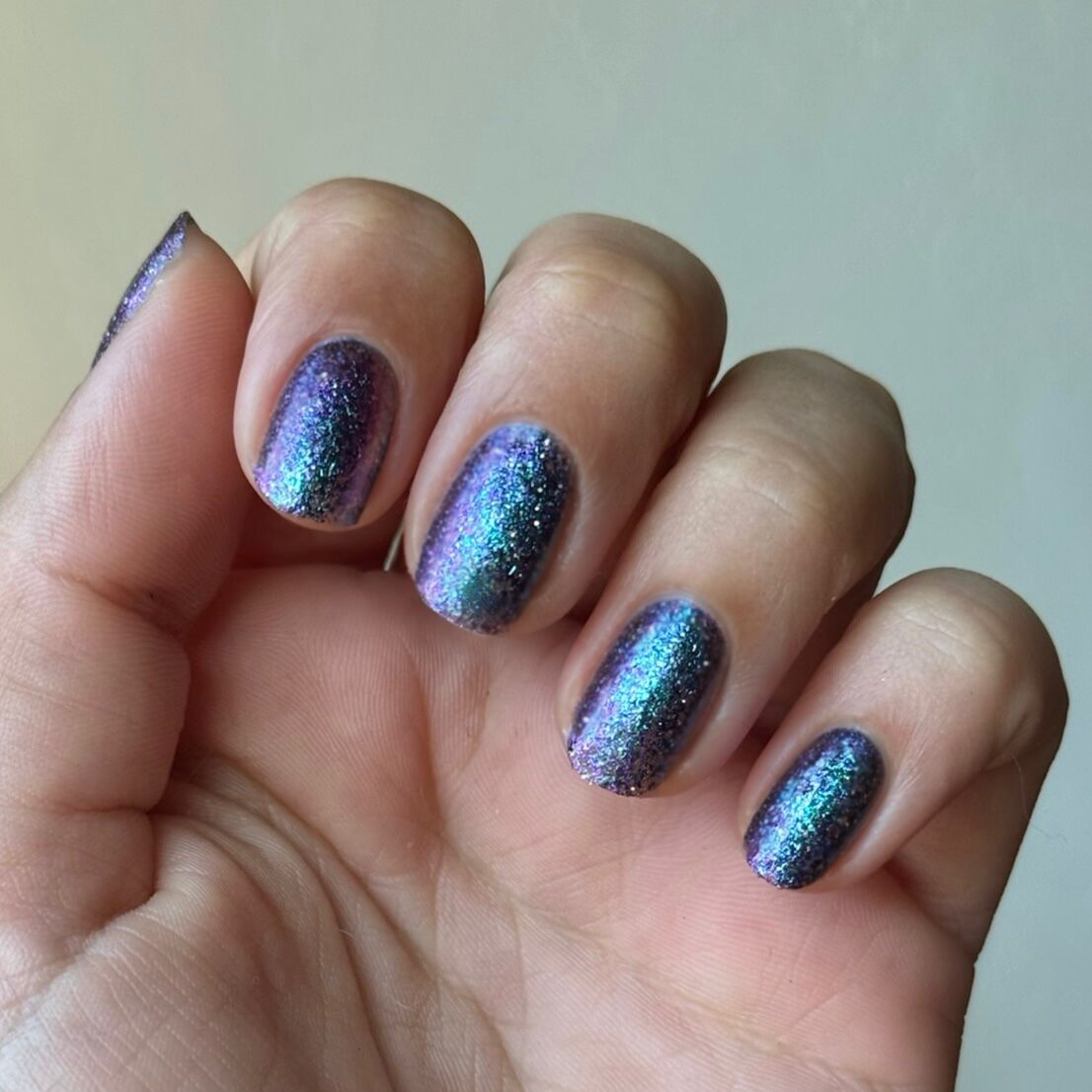 You Obviously Need It iridescent glitter gel polish with purple-blue shimmer on natural medium nails for a sparkling mani