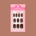 Americano | Short | Squoval - Tab Press-On showing a set of glossy coffee brown false nails in pink packaging on neutral background