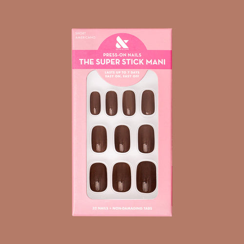 Americano | Short | Squoval - Tab Press-On showing a set of glossy coffee brown false nails in pink packaging on neutral background