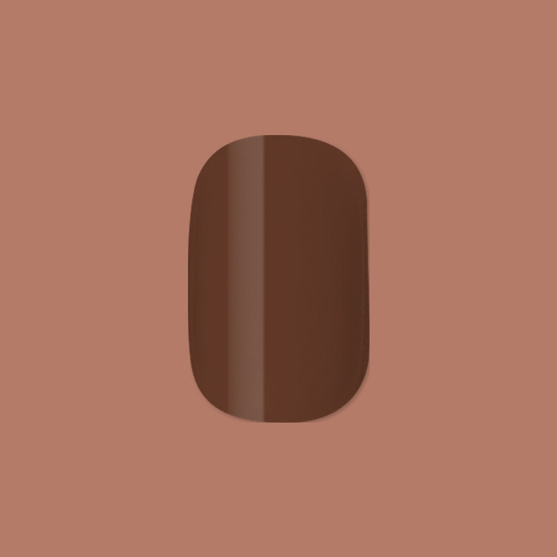 Americano | Short | Squoval - Tab Press-On showing a single glossy coffee brown false nail on muted brown background