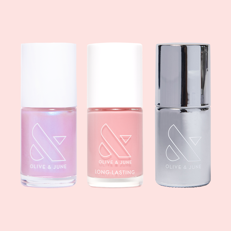 Candy Shoppe nail polish set with shimmering pink, soft pink, and metallic silver bottles on pale pink background