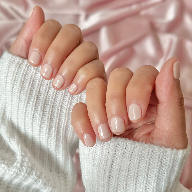 hands with cold foam pls nail polish in subtle shimmery beige for a natural long-lasting manicure at home