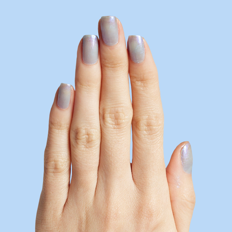 Hand showcasing nails painted in cool lavender-blue iridescent manicure with Friend or Anemone? polish on light blue background