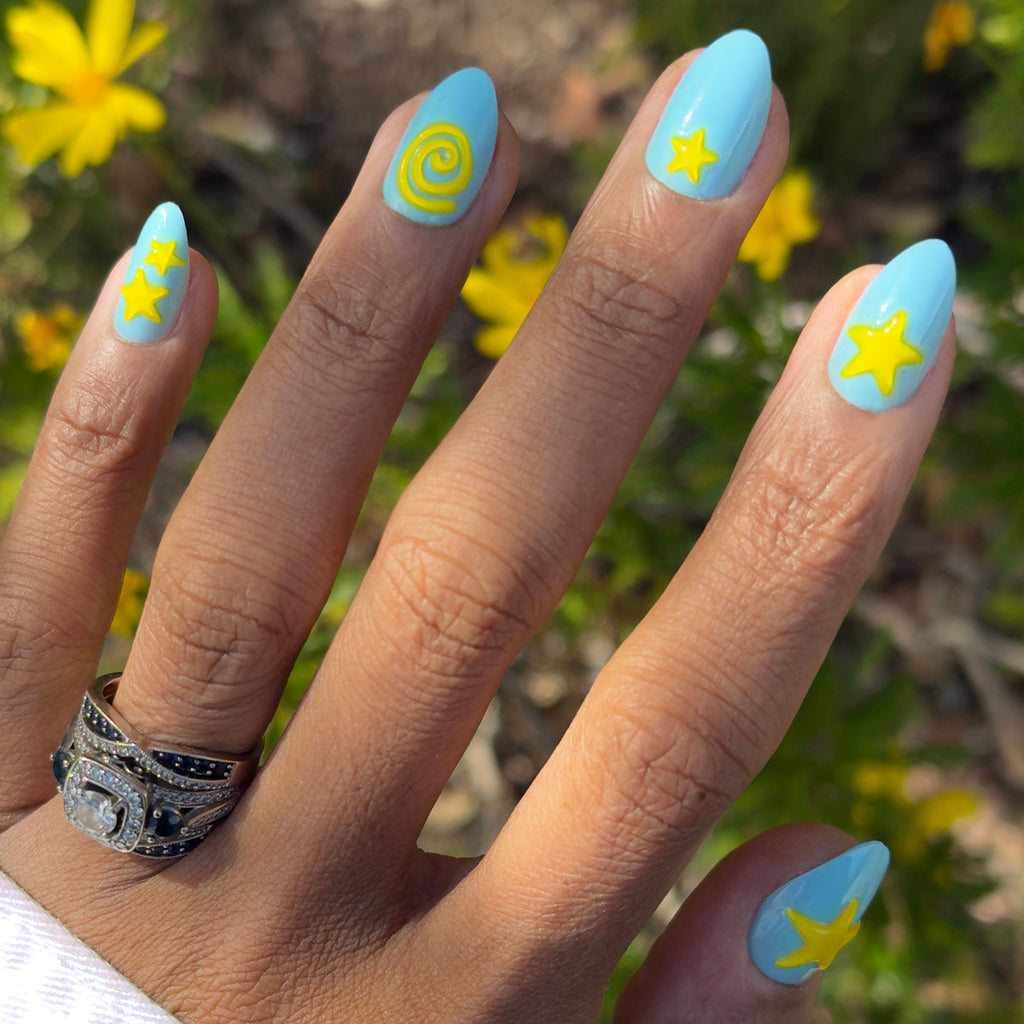 Fun Zone - Press-On | Medium | Almond nails in bright blue with raised yellow star and spiral designs for easy at-home manicure