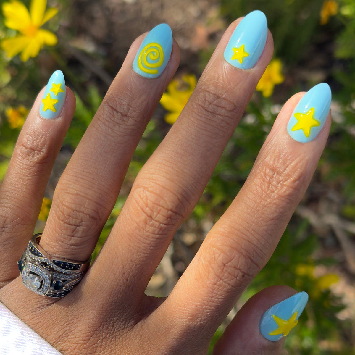Fun Zone - Press-On | Medium | Almond nails in bright blue with raised yellow star and spiral designs for easy at-home manicure