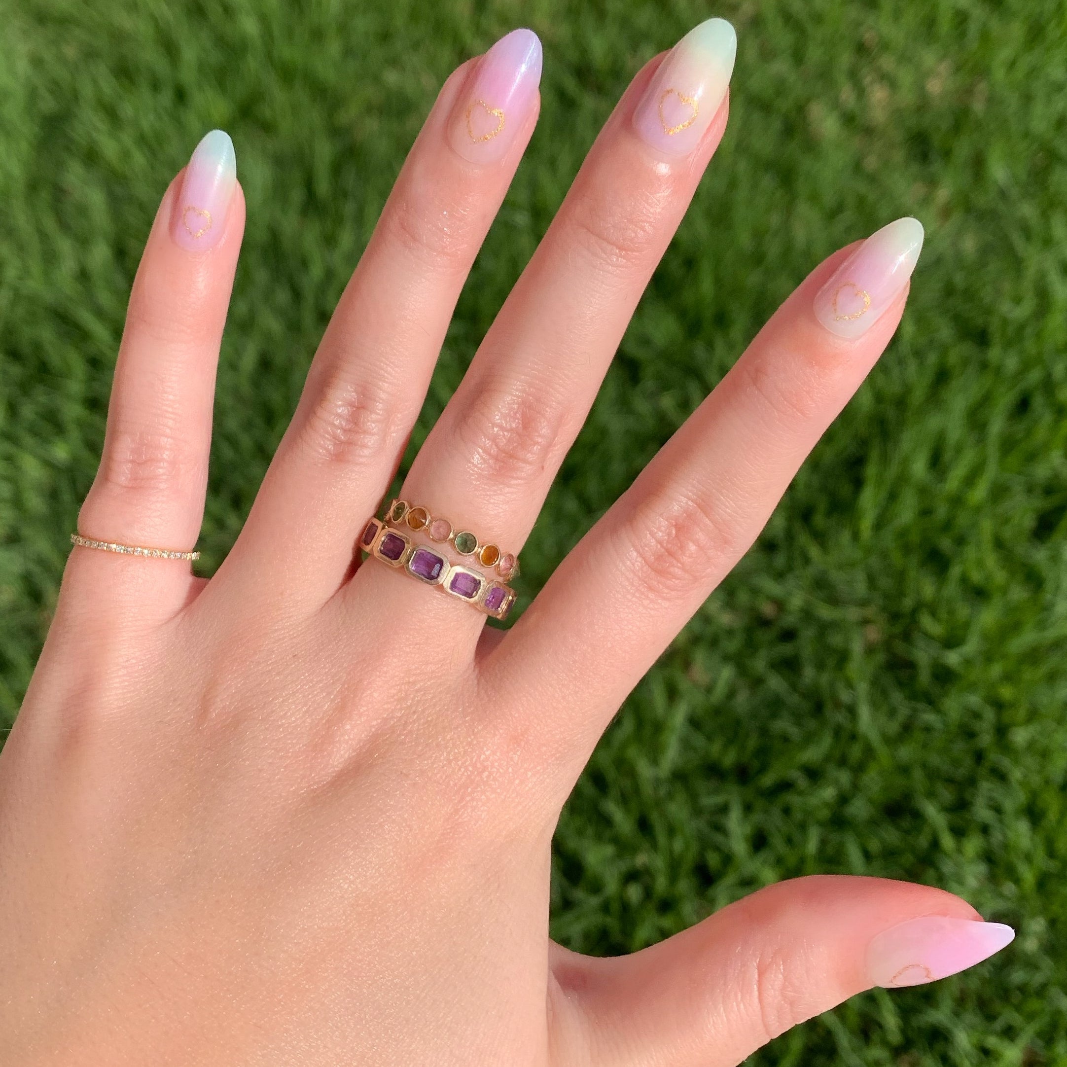 Glitter Heart Ombre | Almond | Medium press-on nails with pastel rainbow fade and subtle gold heart outline manicure