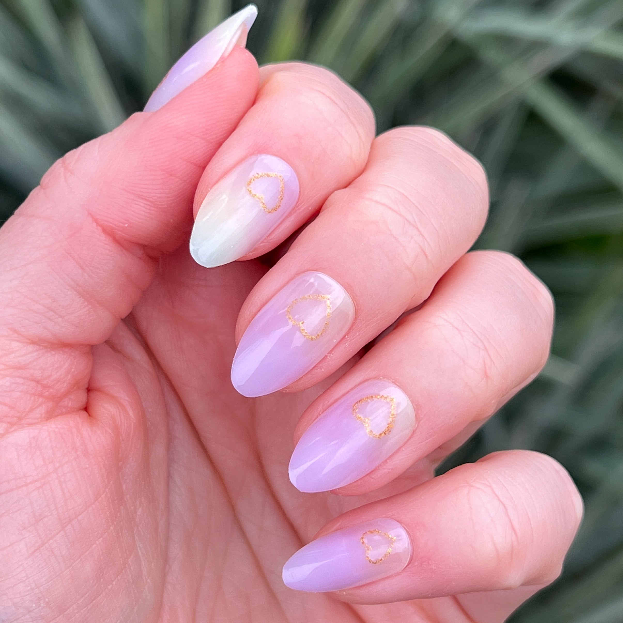 Glitter Heart Ombre | Almond | Medium showing soft purple gradient press-on nails with gold heart outlines manicure