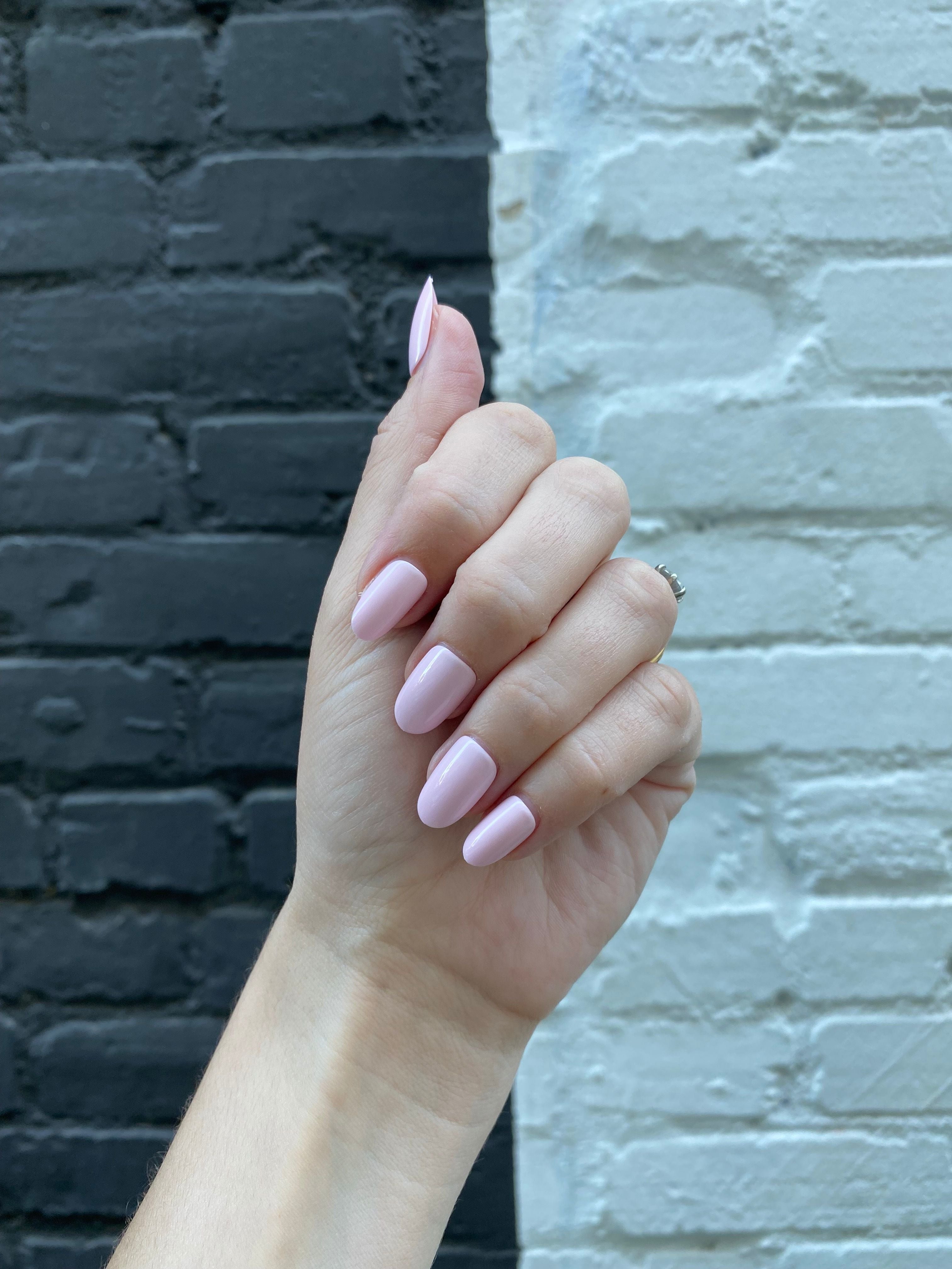 Pink Sands - Press-On | Medium | Oval hand featuring medium oval press-on nails in soft sun-bleached pink polish shade
