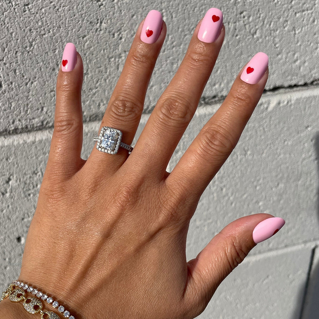 Pink Perfect Heart - Press-On | Round | Short with soft pink base and bright red mini heart designs on natural nails in daylight