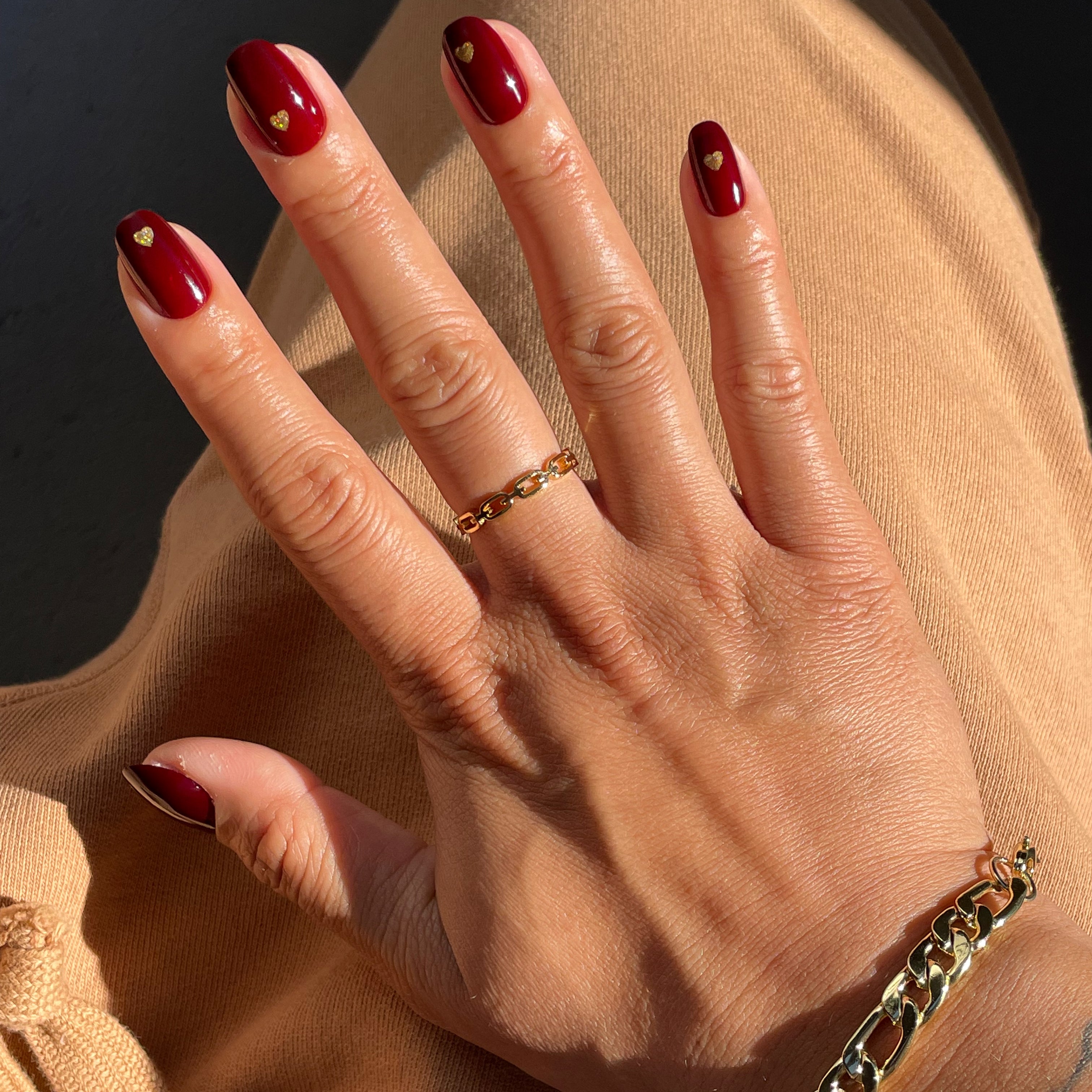 Gold Vampy Heart - Press-On | Short | Round with deep vampy red polish and small gold heart accents for at-home manicure