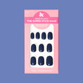 Suited | Extra Short | Round - Tab Press-On showing dark navy false nails in pink packaging on solid blue background