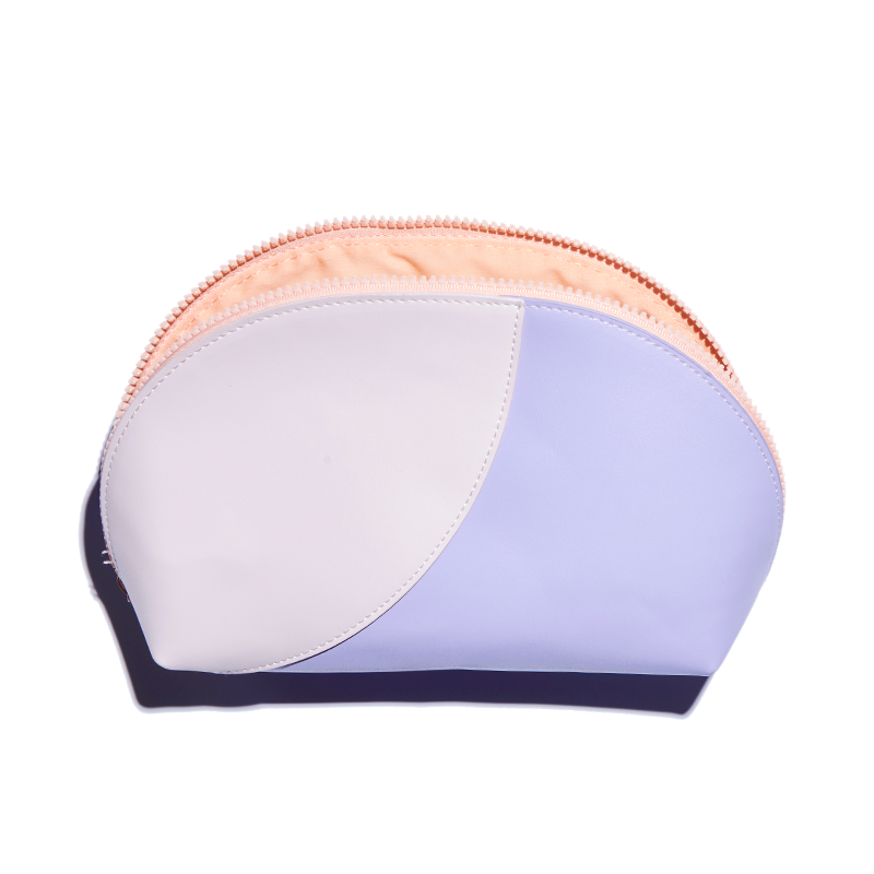 Curved two-tone pink and lavender vegan leather Travel Pouch with zipper open, shown on white background